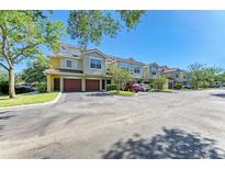 Charming townhomes with red tile roofs, attached garages and well-maintained landscaping at 5001 Baraldi Cir # 22-202, Sarasota, FL 34235
