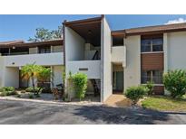 Condo exterior with manicured landscaping, private entry, and visible unit number at 6061 Fairway Ln # 1411, Bradenton, FL 34210