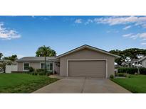 Charming single-story home featuring a well-maintained lawn and attached two-car garage at 7404 14Th W Ave, Bradenton, FL 34209