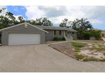 Charming single-story home featuring an attached garage and well-maintained landscaping at 753 Tropical Cir, Sarasota, FL 34242