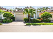 Charming single-story home with beautiful landscaping and a brick paver driveway, providing curb appeal at 7747 33Rd E St, Sarasota, FL 34243