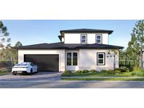 Two-story home with a dark garage door, manicured lawn, and modern architectural design at 9225 Raes Creek Pl, Palmetto, FL 34221