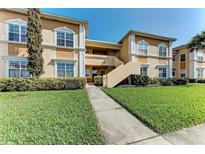 Two-story exterior with well-manicured lawn and inviting entryway, great for curb appeal at 1030 Villagio Cir # 103, Sarasota, FL 34237