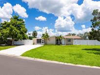 Charming home featuring a well-manicured lawn and a white picket fence at 2416 Emory Ave, Bradenton, FL 34207