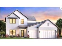 Charming two-story home with a three-car garage, modern design, and professionally landscaped front yard at 2593 Waterfront Cir, Sarasota, FL 34240