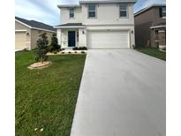 Charming two-story home with attached two car garage and well manicured lawn at 2824 Rock Sound St, Bradenton, FL 34208