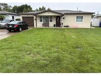 Charming single-story home with a well-maintained lawn, attached garage, and inviting front porch at 4337 15Th N Ave, St Petersburg, FL 33713