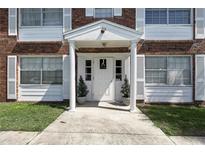 Apartment entrance featuring a white door and columns with white shutters and potted plants at 4507 9Th W St # J11, Bradenton, FL 34207