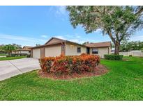 Charming home featuring a well-manicured lawn, vibrant landscaping, and inviting curb appeal at 495 Oak Hill Cir # 44, Sarasota, FL 34232