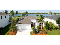 Beautiful waterfront home featuring lush tropical landscaping, and an attached two car garage at 5078 47Th W St, Bradenton, FL 34210