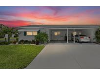 Charming single-story home featuring a covered carport and well-maintained landscaping at 6016 Hibiscus Dr, Bradenton, FL 34207