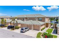 View of three attached townhomes with a shared driveway and tile roof on a sunny day at 6604 7Th Avenue W Cir, Bradenton, FL 34209