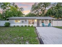 Charming single-story home featuring a well-maintained front lawn and gravel driveway at 946 Charlotte Ave, Sarasota, FL 34237