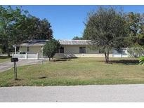Charming single-story home with a well-maintained lawn, mature trees, and cozy curb appeal at 1105 17Th W Ave, Palmetto, FL 34221