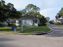 Charming single-story home with a cozy front porch, nestled on a tree-lined street corner lot at 2102 Arlington St, Sarasota, FL 34239