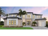 Stunning two-story home features a meticulously landscaped yard, a modern design, and elegant architectural details at 2425 Waterfront Cir, Sarasota, FL 34240
