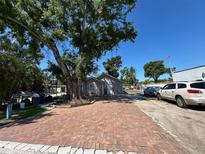 Charming home featuring a brick driveway, complemented by mature trees providing ample shade at 2804 11Th Street E Ct, Bradenton, FL 34208
