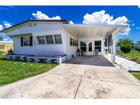 Inviting home exterior with a covered porch and well-maintained lawn and features a long driveway for easy parking at 508 50Th Avenue W Plz, Bradenton, FL 34207