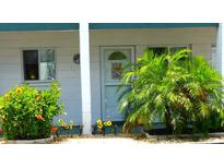 Inviting front door entrance with colorful landscaping and a welcoming aesthetic at 1850 Sunny Dr # F4, Bradenton, FL 34207