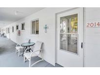 Condo exterior showcasing a cozy seating area and the unit's front door at 2014 Canal Dr # M6, Bradenton, FL 34207
