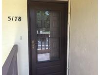 Inviting front door with glass panel and visible address number at 5178 Lake Village Drive # 86, Sarasota, FL 34235