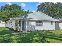 Charming single-story home with a freshly painted exterior and well-manicured lawn at 5718 Magnolia N St, St Petersburg, FL 33703