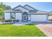 Charming single-story home featuring a beautifully manicured lawn and a two-car garage at 7005 Goldrush Ln, Bradenton, FL 34201