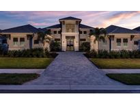 Stunning two-story home features beautiful landscaping and a brick driveway leading to the home's entrance at 1166 Blue Shell Loop, Sarasota, FL 34240