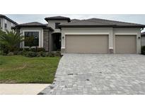 Charming one-story home with a paver driveway, neutral color palette and well-manicured landscaping at 15437 White Linen Dr, Bradenton, FL 34211