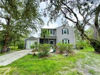 Charming two-story home featuring black shutters, well-maintained landscaping, and an attached garage at 25640 State Road 70 E, Myakka City, FL 34251