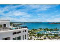 A panoramic view from atop a building overlooks a marina and bay on a bright, sunny day at 33 S Palm Ave # 1501, Sarasota, FL 34236