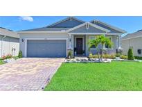 Charming single-story home features manicured lawn, brick driveway, and welcoming front entrance at 3419 74Th Avenue E Cir, Sarasota, FL 34243