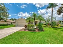 Charming single-story home featuring well-manicured lawn, mature landscaping, and a two-car garage at 6644 Butlers Crest Dr, Bradenton, FL 34203