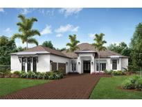 Stunning home featuring a brick driveway, three-car garage, lush landscaping, and elegant architectural details at 17832 Signature Pl, Bradenton, FL 34202