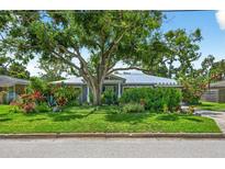 Charming one-story home with lush, mature landscaping and a metal roof at 2460 Hillview St, Sarasota, FL 34239