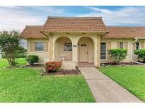 Charming home featuring a covered front porch with arched entryway and lovely landscaping at 3905 34Th Avenue W Dr # 36, Bradenton, FL 34205