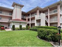 Three-story condo complex with balconies and well-maintained landscaping at 6505 Stone River Rd # 309, Bradenton, FL 34203