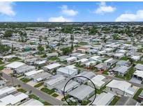 Wide aerial view of a mobile home park under a partly cloudy sky at 719 50Th Avenue W Ter, Bradenton, FL 34207