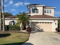 Charming two-story home with a lush landscaped yard, two-car garage and neutral colored exterior at 12342 Lavender Loop, Bradenton, FL 34212