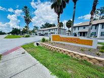 Street view of Sunridge Condominiums showcasing the community entrance sign and well-maintained landscaping at 5238 Sunridge Palms Dr, Tampa, FL 33617