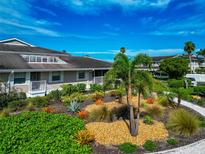 Charming home featuring an attractive landscape with stone and tropical plants under a beautiful blue sky at 719 Estuary Dr # 719, Bradenton, FL 34209