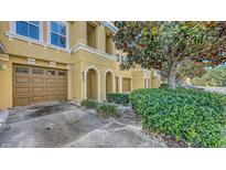 Charming townhome featuring a private garage, arched entryway, and manicured landscaping at 8823 White Sage Loop # 1802, Lakewood Ranch, FL 34202