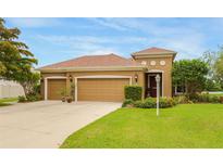 Charming one-story home with a three-car garage, landscaped yard, and freshly cut lawn at 2819 47Th E St, Palmetto, FL 34221