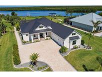 Aerial view of waterfront home with modern farmhouse design at 2073 Treasure Ln, Punta Gorda, FL 33982