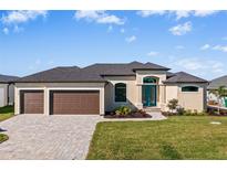 Two-car garage, landscaping and home exterior at 9437 Galaxie Cir, Port Charlotte, FL 33981
