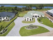 Luxury home with circular driveway and landscaping at 2033 Treasure Ln, Punta Gorda, FL 33982