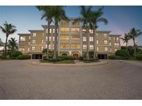Building exterior at dusk, featuring palm trees at 255 West End Dr # 1412, Punta Gorda, FL 33950