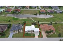 Aerial view of a single-Gathering home with a large backyard and a golf course nearby at 2325 Padre Island Dr, Punta Gorda, FL 33950