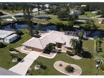 Aerial view of single-Gathering home with canal views and lush landscaping at 27200 San Marino Dr, Punta Gorda, FL 33983