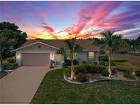 Attractive single-story home with landscaped yard and driveway at 244 Mark Twain Ln, Rotonda West, FL 33947